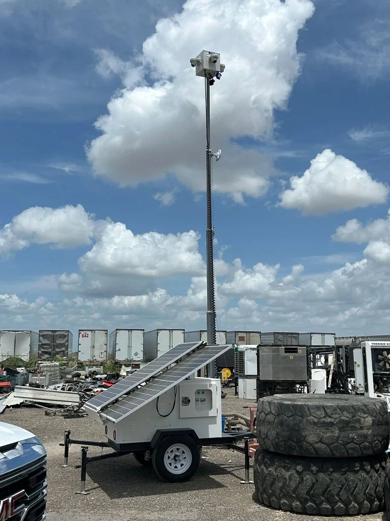 Industrial solar surveillance trailer with telescopic mast cameras.